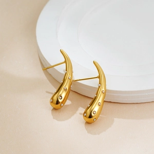 Polished 18K gold plated water drop earrings with white pearls on a minimalist pedestal