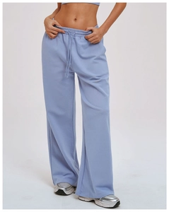 Detail of light blue wide-leg sweatpants showing elastic drawstring waist and fabric texture