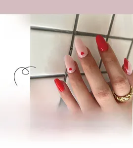 Detail of French red and nude press-on nails with heart patterns in medium round shape