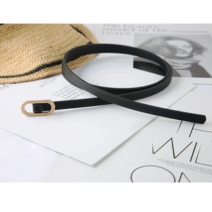 Elegant thin black leather belt with gold matte oval buckle on a stylish background