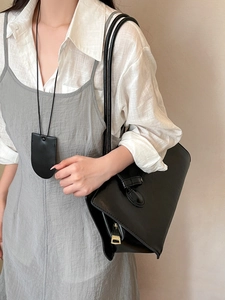 Chic faux leather magnetic glasses holder pendant worn by model on minimalist sweater