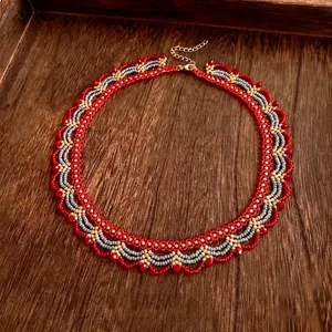 Handmade woven glass bead necklace in red and gold with retro palace style aesthetic
