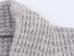 Macro shot of grey double-breasted cashmere knitwear with silver glitter thread texture