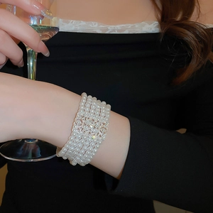 Detail of five-layer pearl bracelet with rhinestone-studded rectangular silver hollow clasp