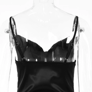 Detail of adjustable spaghetti straps and low back on a black satin evening gown
