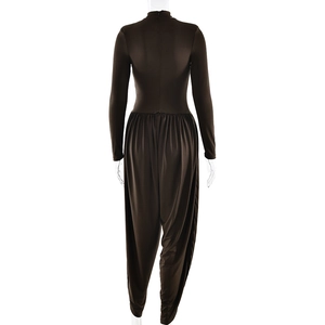 Detail view showing the back of a slim-fit dark brown long sleeve backless jumpsuit