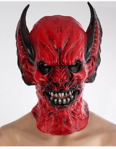 Detailed view of scary red devil latex mask with large black horns and sharp fangs