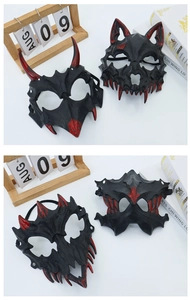 Close-up detail of Halloween devil and werewolf half-face masks with red blood stains
