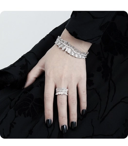 Detail of pleated silver S925 sterling silver cuff bracelet and matching ring set