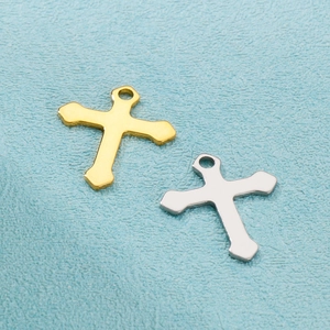Detail of minimalist stainless steel cross pendants in gold and silver finishes