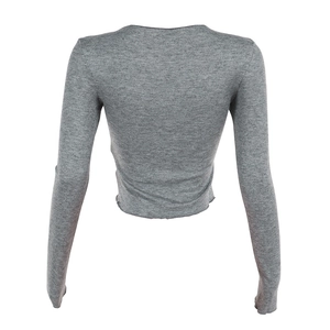 Detail view of the back of a grey long-sleeved cropped knitted top for women