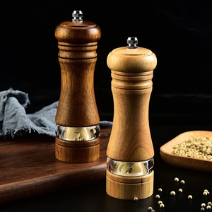 Manual wood and acrylic pepper grinders with ceramic core shown in dark and light finishes