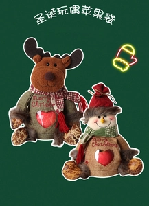 Detail of Christmas burlap gift bags with reindeer, snowman and heart window showing apples