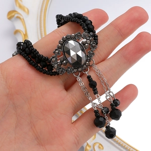 Detail of Y2K gothic choker with black beads and grey rhinestone pendant