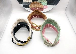 Close-up of handmade bohemian braided cotton hairbands in various assorted colors