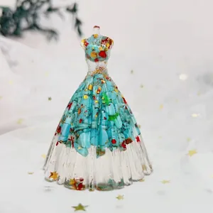 Macro detail of crystal gown figurine featuring blue stones and gold star sequins