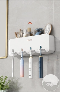 Macro view of wall-mounted toothbrush holder with multiple storage slots for toiletries