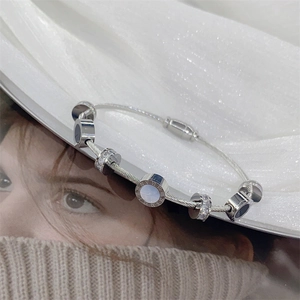Silver cable wire bangle featuring roman numerals and crystal accents in a stylish design