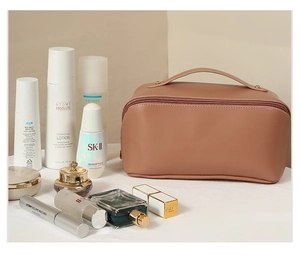 Pink PU leather makeup bag with wide opening and large capacity shown with cosmetics