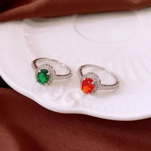 Zircon oval open ring with green and red stones in classic silver micro-pave setting