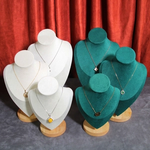 Elegant velvet necklace display bust with round wooden base in cream and dark green colors