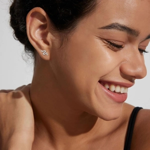 Close-up of s925 silver snake earring with sparkling moissanite on model ear