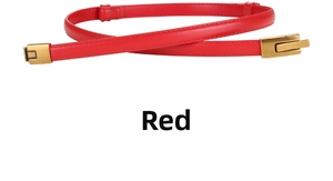 Detail of red thin leather belt with lychee texture and vintage gold metal buckle