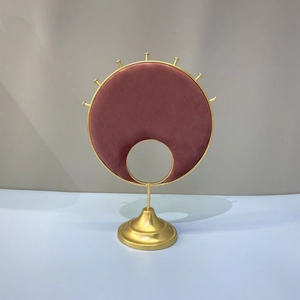 Golden jewelry display stand with wine red velvet panel and circular metal hooks