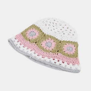 Detail of hand-crocheted bucket hat with floral granny square patterns and scalloped edges