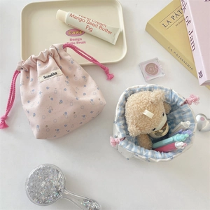 Detailed view of floral drawstring storage pouches with pink and blue fabric patterns