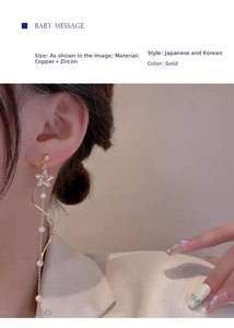 Detailed view of long gold star tassel earrings with pearls on a female model