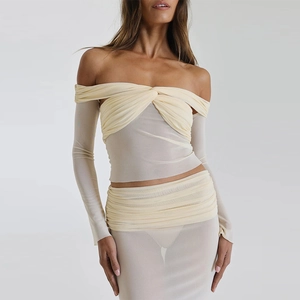 Detail of ruched beige mesh two-piece set featuring sheer off-shoulder long sleeves