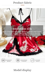 Dettaglio della camicia da notte in raso di seta rossa con pizzo nero e fiori bianchi