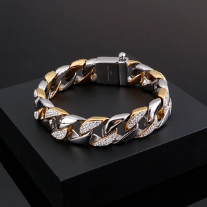 Macro shot of 316L stainless steel Cuban chain bracelet with gold-silver tones and zircons