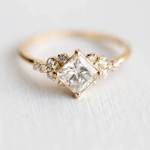 Elegant gold plated ring featuring a princess cut square zircon and pave side stones