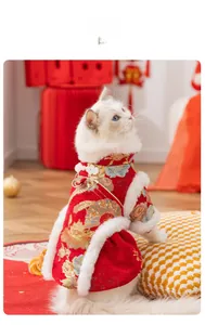 Detailed embroidery and white faux fur trim on a traditional red festive cat dress