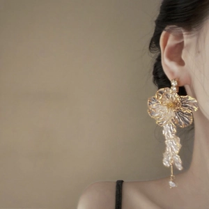 Elegant floral tassel earrings with acrylic petals and pearl drop in gold finish