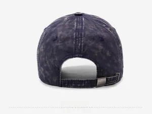Detail of adjustable metal buckle on distressed navy washed denim baseball cap