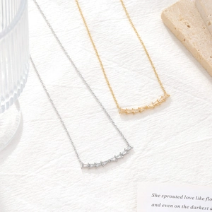 Elegant minimalist curved bar necklace with square-cut crystals in gold and silver finish