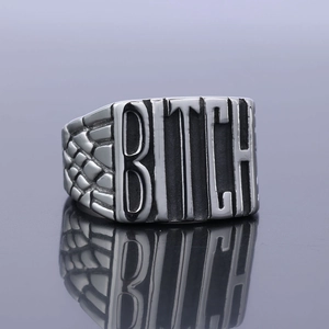 Punk rocker style silver stainless steel ring with bold BITCH engraving and scale texture