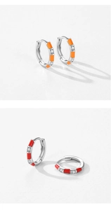 Detailed macro view of S925 silver hoop earrings with orange and red enamel and crystals