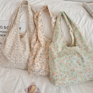 Detailed view of three floral canvas tote bags with soft texture and wide shoulder straps