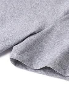 Macro detail of the gray knitted fabric showing double-stitched hem and fine fiber texture