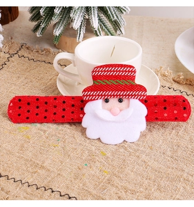 Close-up of a festive red sequined slap bracelet featuring a plush Santa Claus character