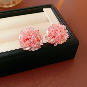 Close-up of pink beaded cluster earrings with crystal accents in a black jewelry box
