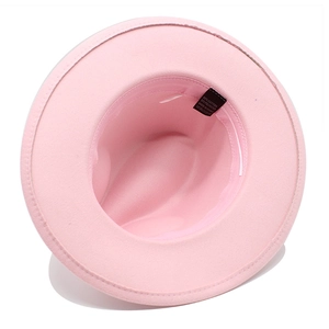 Overhead view of pink fedora hat interior showing cotton blend fabric and care label