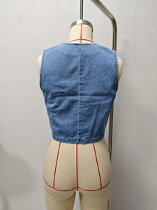 Detail view of the back of a blue denim vest with trendy lace-up ties for women