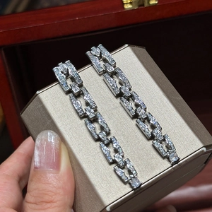 Detailed view of silver chain drop earrings with micro-pave cubic zirconia accents