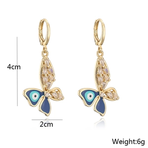 Detailed view showing dimensions and weight of gold butterfly earrings with blue evil eye motif