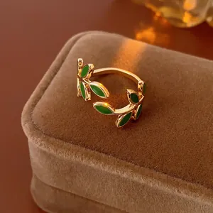 Vintage gold leaf open ring with green enamel finish on premium velvet jewelry box